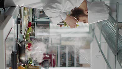 Vertical video: People cooking professional food recipe in restaurant kitchen