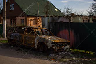 Velyka Dymerka, Kyiv region, Ukraine - April 2022: War Ukraine Russia. The ruins of a house and a blown up car of civilians after