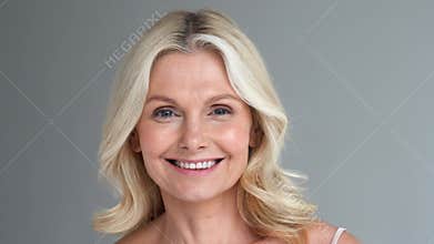 Happy healthy thirsty fit middle aged 50s woman holding glass drinking water.