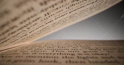 Sliding inside book between sheets of paper with text. knowledge and education concept