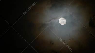 The clouds passed through the full moon on a cloudy night