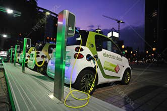 Electric cars powering at charging station