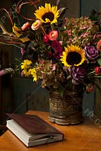 Rustic still life with autumn flowers and book
