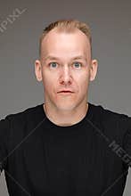 Staged photo of shocked man in black clothes