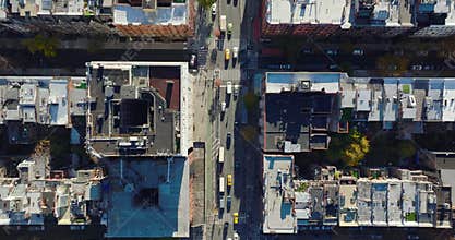 Aerial birds eye overhead top down panning view of busy street in urban neighbourhood. Manhattan, New York City, USA