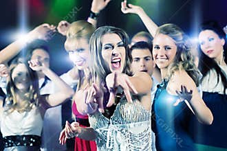 Party people dancing in disco club