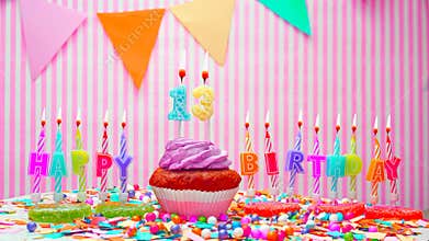 Happy birthday number 13. On a pink background, congratulations on the birthday of the thirteen year old. Muffins with pink