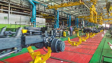Conveyor assembly stage the body of tractor at big industrial factory timelapse