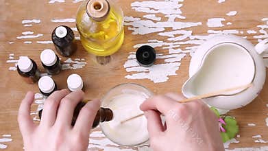 Women`s hands mix different natural ingredients for cosmetic cream