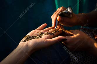 Henna being applied