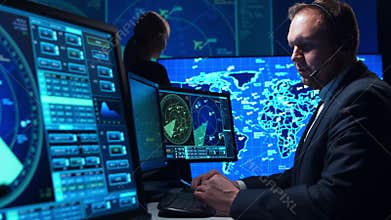 Workplace of the air traffic controllers in the control tower. Team of aircraft control officers works using radar