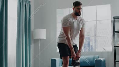 Muscular sportsman practices deadlift with cast iron weight