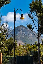 Street view to Monte Vico Alvano mountain with big cross on top