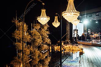 candle light in glass lanterns and gorgeous lamp at luxury wedding ceremony in evening, decor and arrangements