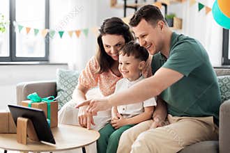 happy family with tablet pc at home on birthday