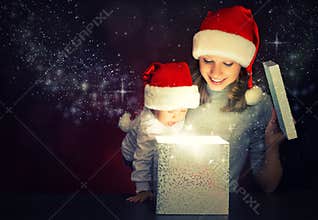Christmas magic gift box and a happy family mother and baby