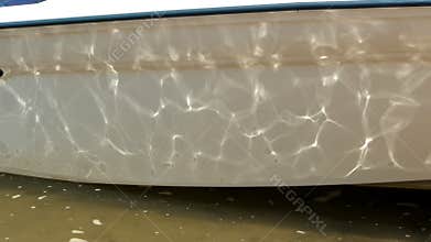 Water reflects off boat