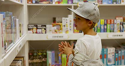 Boy choosing between board games in toy store