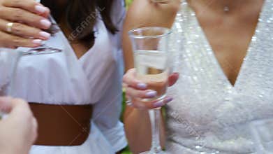 women in white dresses with glasses of champagne. Bachelorette party.