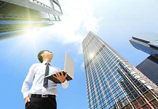 Business man with laptop and look sky and cloud