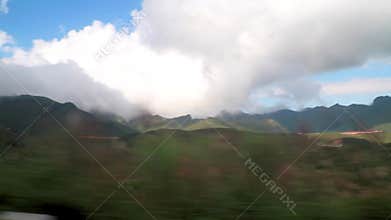Driving through the mountain landscape dusty and high in Laos