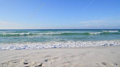 Emerald waters rolling up on pristine white sand beach in Florida