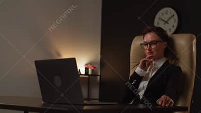 Stocks market broker adult woman using notebook in office. A young business assistant in formal wear thinking how answer