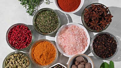 Spices and herbs in bowls, top view
