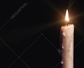 Burning candle over black