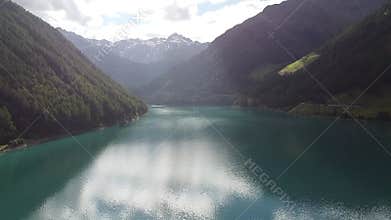 Turquoise water reflecting the blue sky of a sunny summer day at Lake Vernago in Trentino Alto Adige, Italy