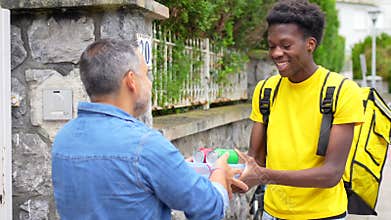 Delivery man deliver food to a client at home