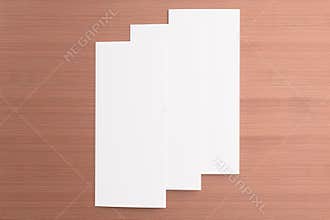 Blank tri fold brochure on wooden background
