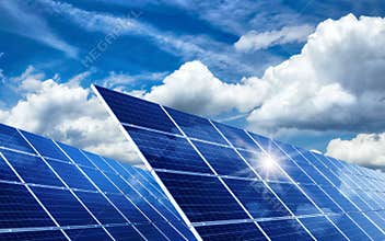 Solar panels reflecting the sun and clouds