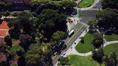 Urban Buenos Aires from above. Aerial drone view of city streets, traffic, green lanes. Modern