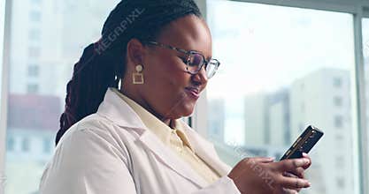 Smiling Black Doctor Using Smartphone In Office