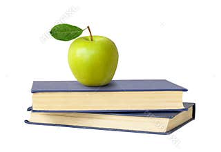 Two books and a green apple isolated on white background