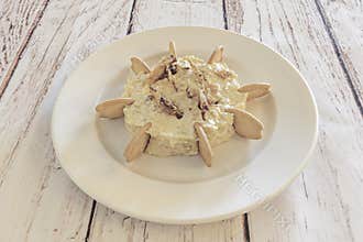 The mixed and chilled Russian salad, with a creamy consistency, next to croutons or toast for spreading, on a picnic table