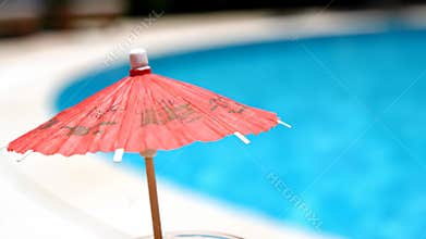 Enjoying a Refreshing Drink by the Swimming Pool on a Sunny Summer Day