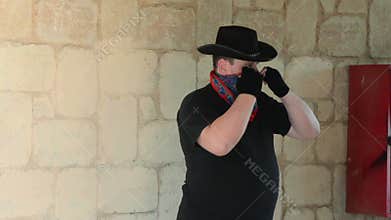 Cowboy wearing bandana scarf on his face