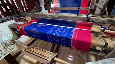 Traditional Thai Handloom Weaving: Close-up of Shuttle Flying Through Cotton Yarn