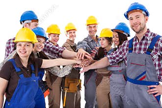 Diverse group of construction workers stacking hands
