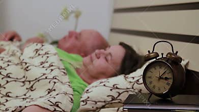 Mature couple in bed sleeping