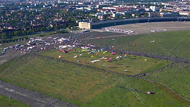 People flying colorful giant kite at festival. Majestic aerial view flight drone