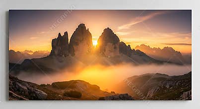Tre Cime di Lavaredo mountains at sunrise with golden mist image