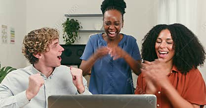Excited Diverse Startup Team Celebrates Achieving Goals and Success with Laptop in Modern Office