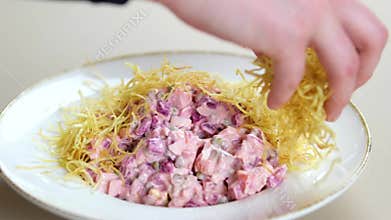 Sprinkle fried potato slices over salad