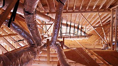 Workers install ductwork in new building under construction