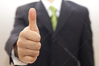 Business man in black suit with thumbs up
