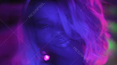 Close up happy blond afro american girl dancing in the night club. Charming glamour dancer in silver sequins dress dance