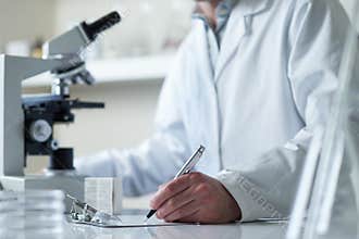 Scientist conducting research with microscope